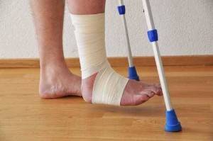 person with a hurt ankle and crutches