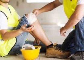 injured construction worker with wrapped knee