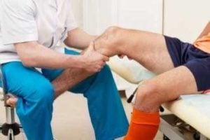 doctor rubbing a patient's knee