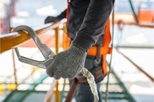 Construction Worker Holding on tightly to a safety harness