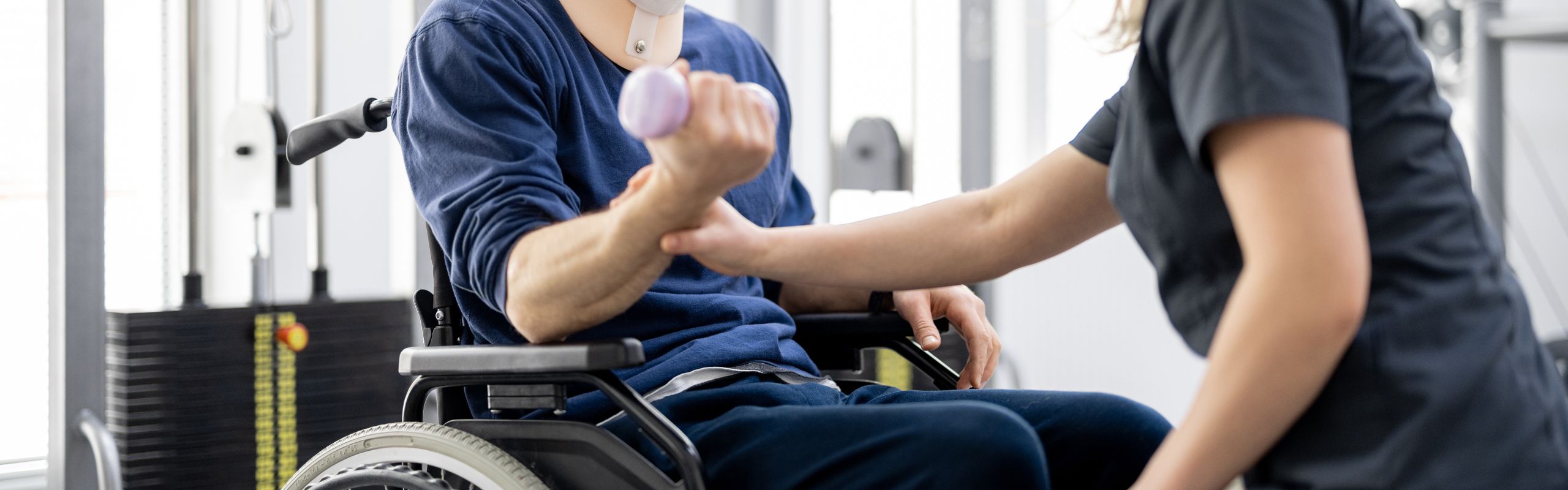 person in wheelchair engaging in physical therapy